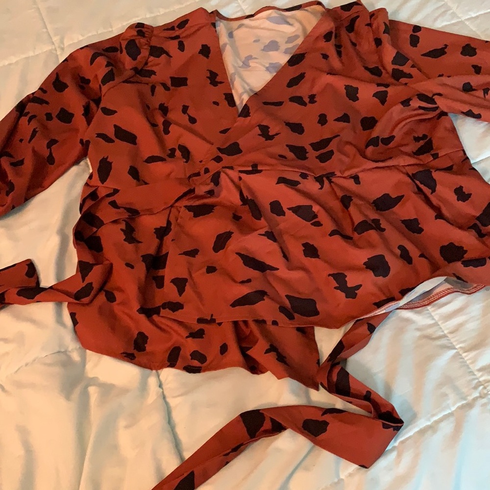 Blouse is cute it’s a wrap around blouse if heavy chested this for you